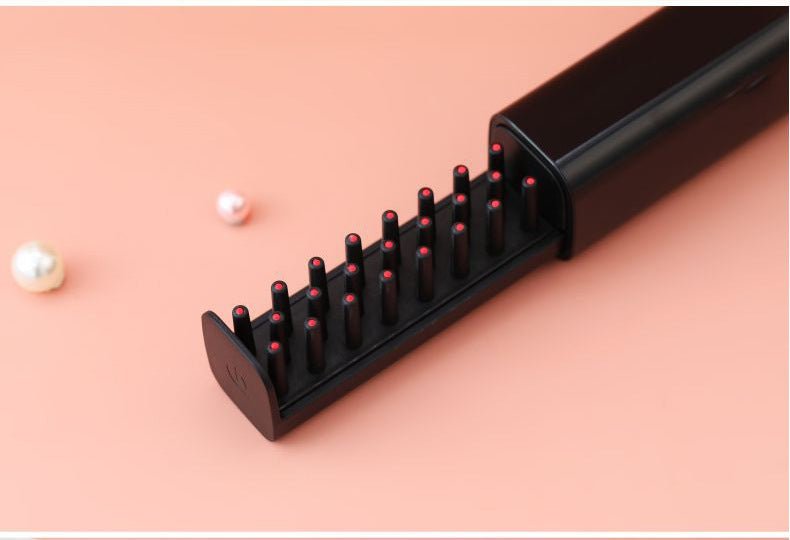 Red Light Hair Health Comb and massager tip against background